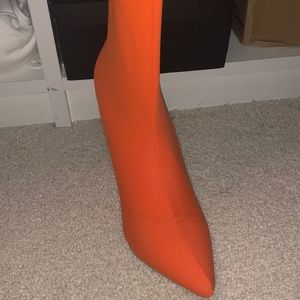 Thigh high boots in a bright Orange.